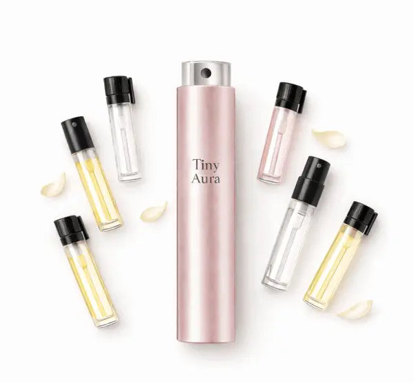 Collection of 'Tiny Aura' perfume bottles on a white background