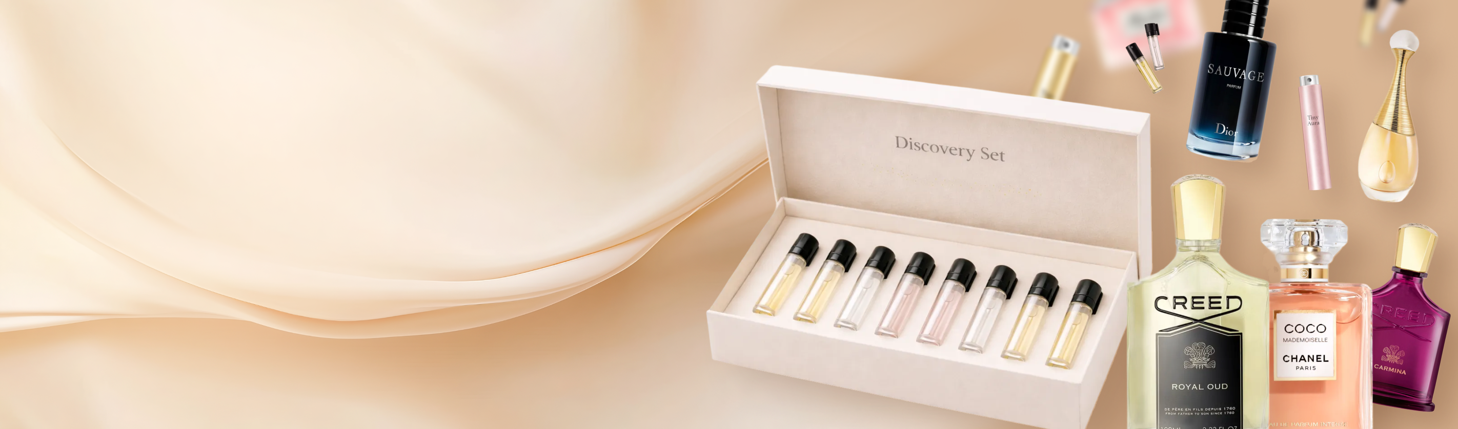 Set of Creed perfume samples in a box with Creed bottles in the background