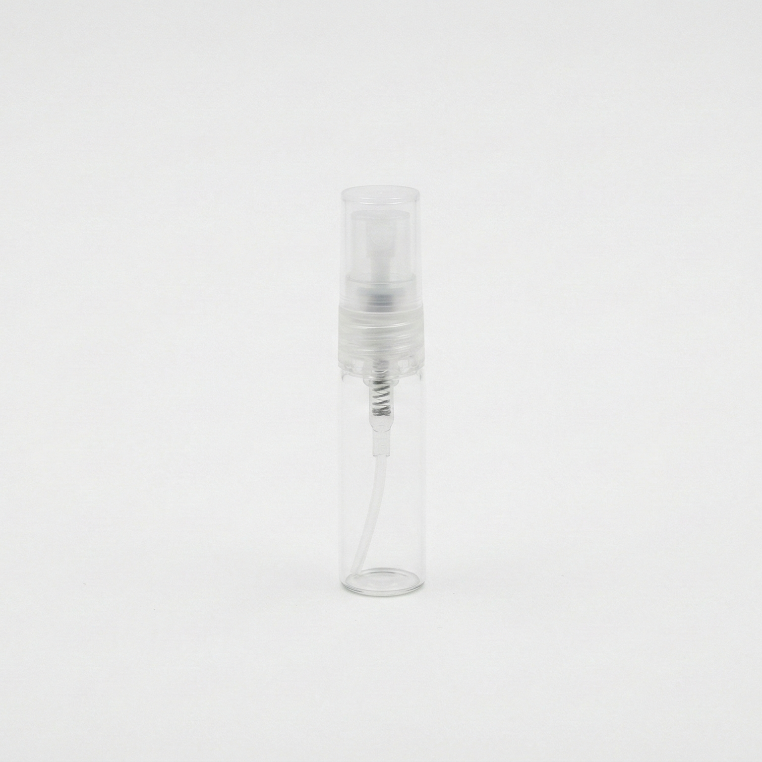 Clear glass bottle with a white cap on a white background