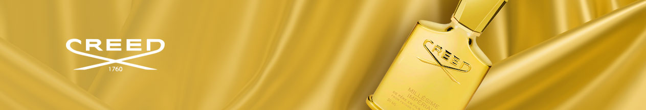 A gold bottle of Creed Millésime Impérial perfume displayed on a luxurious golden silk background, with the Creed logo on the left.